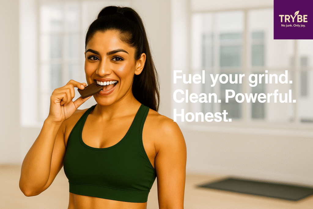 Woman in athletic wear smiling while holding TRYBE protein bar, with motivational text overlay.